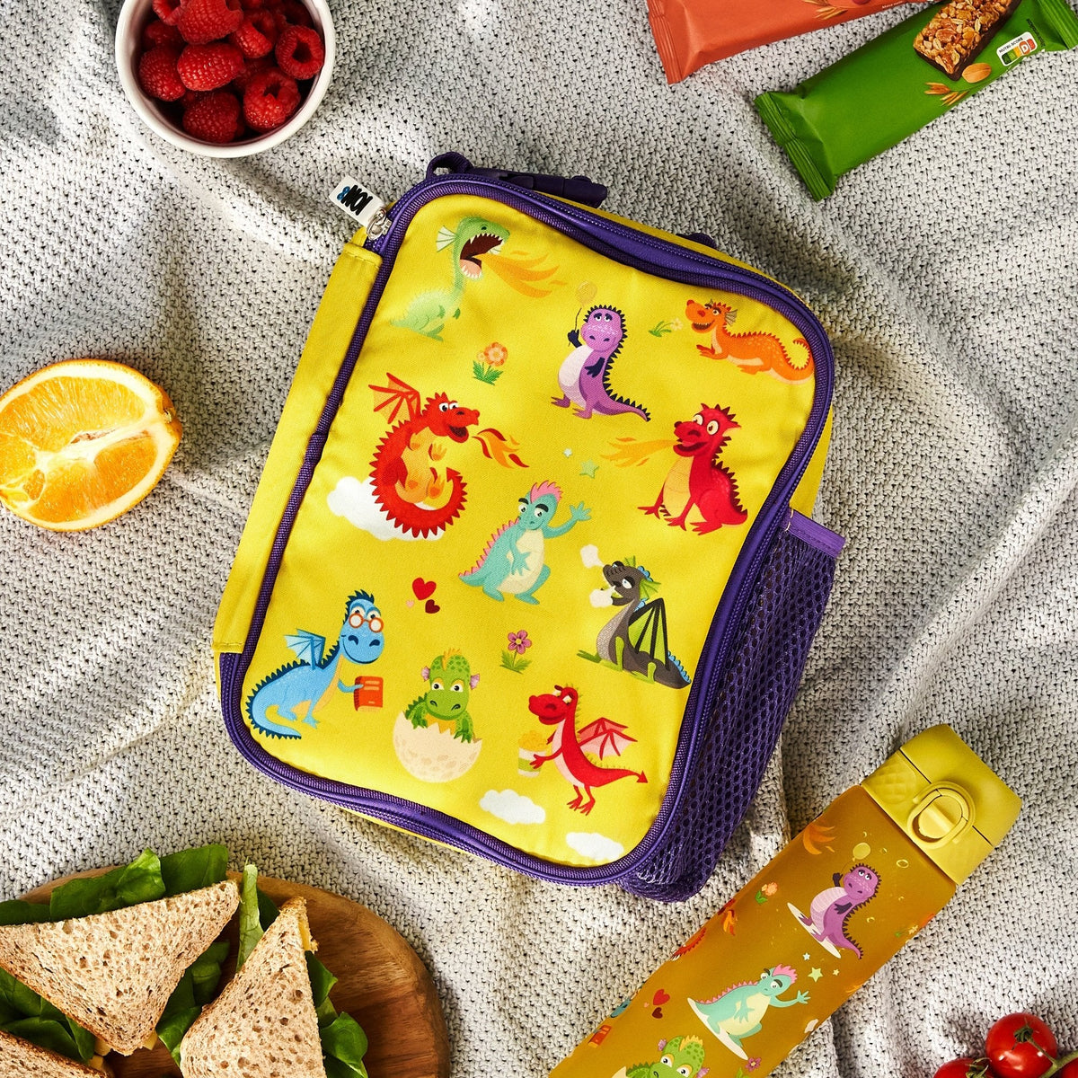 ION8 Dragons lunch bag and bottle set in use on a picnic