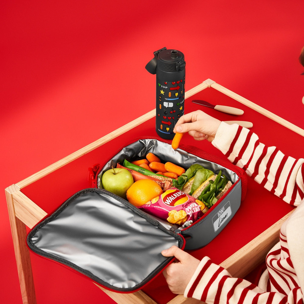 ION8 Gamer lunch bag and bottle set in use, packed with a healthy lunch