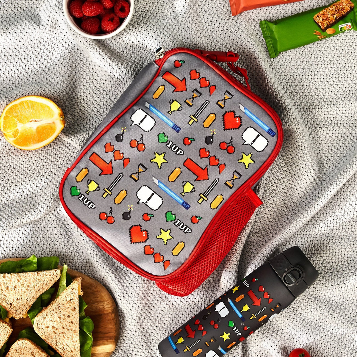 ION8 Gamer lunch bag and bottle set in use on a picnic