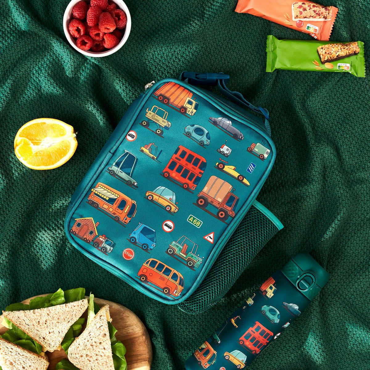ION8 Automobiles lunch bag and bottle set in use on a picnic