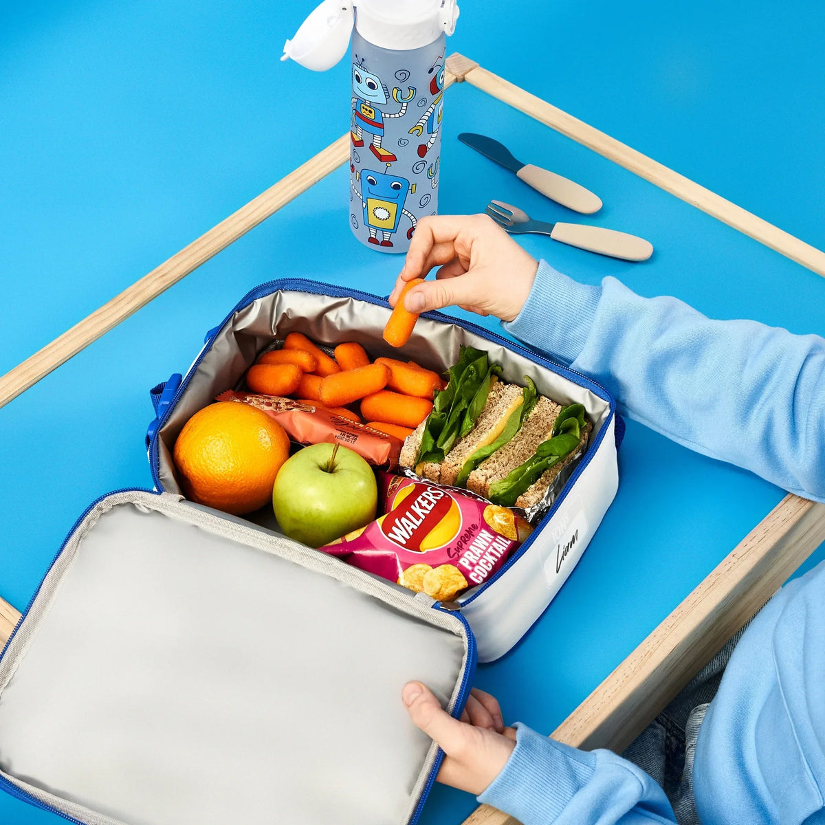 ION8 Robots lunch bag and bottle set in use, packed with a healthy lunch