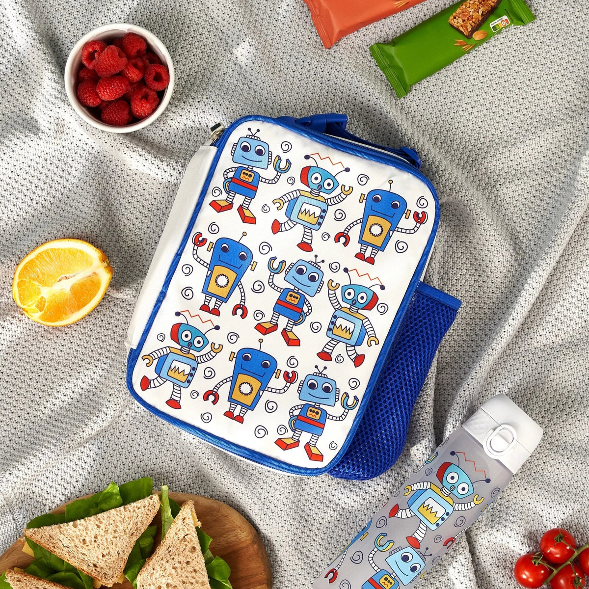 ION8 Robots lunch bag and bottle set in use on a picnic