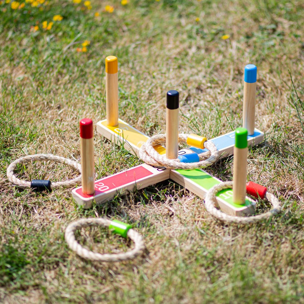 Bigjigs Wooden Quoits Game set up on the lawn in the garden