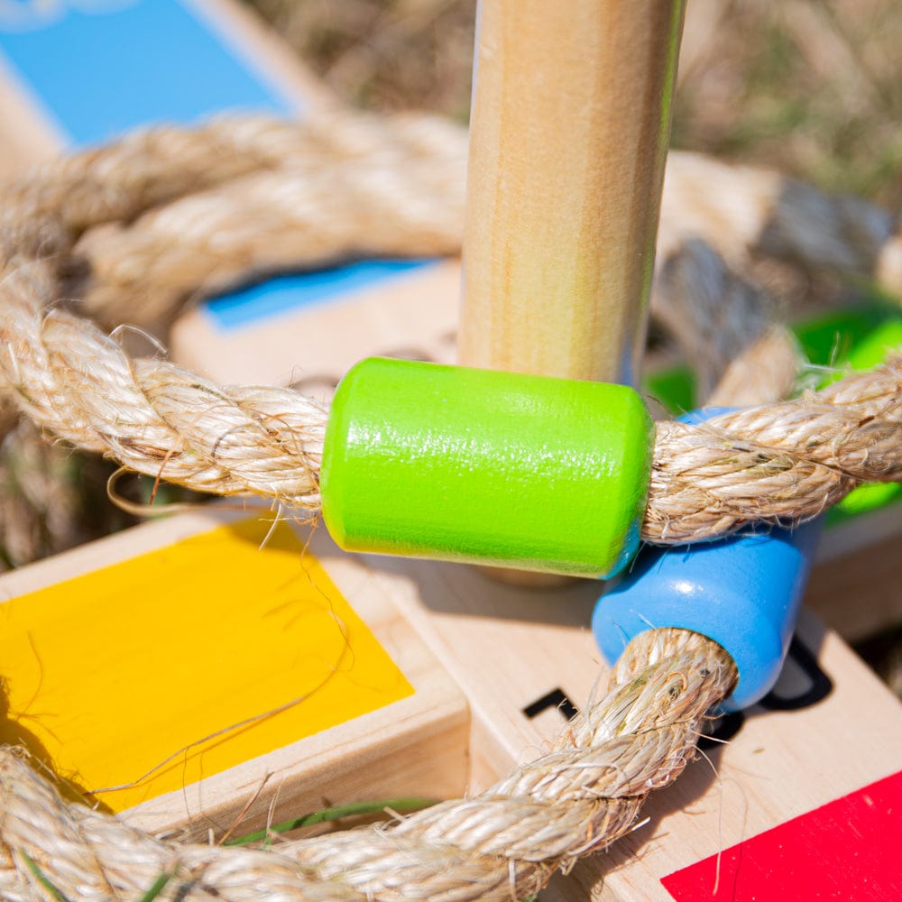 Close-up of a Bigjigs rope quoit ring with its colourful wooden bead on a peg