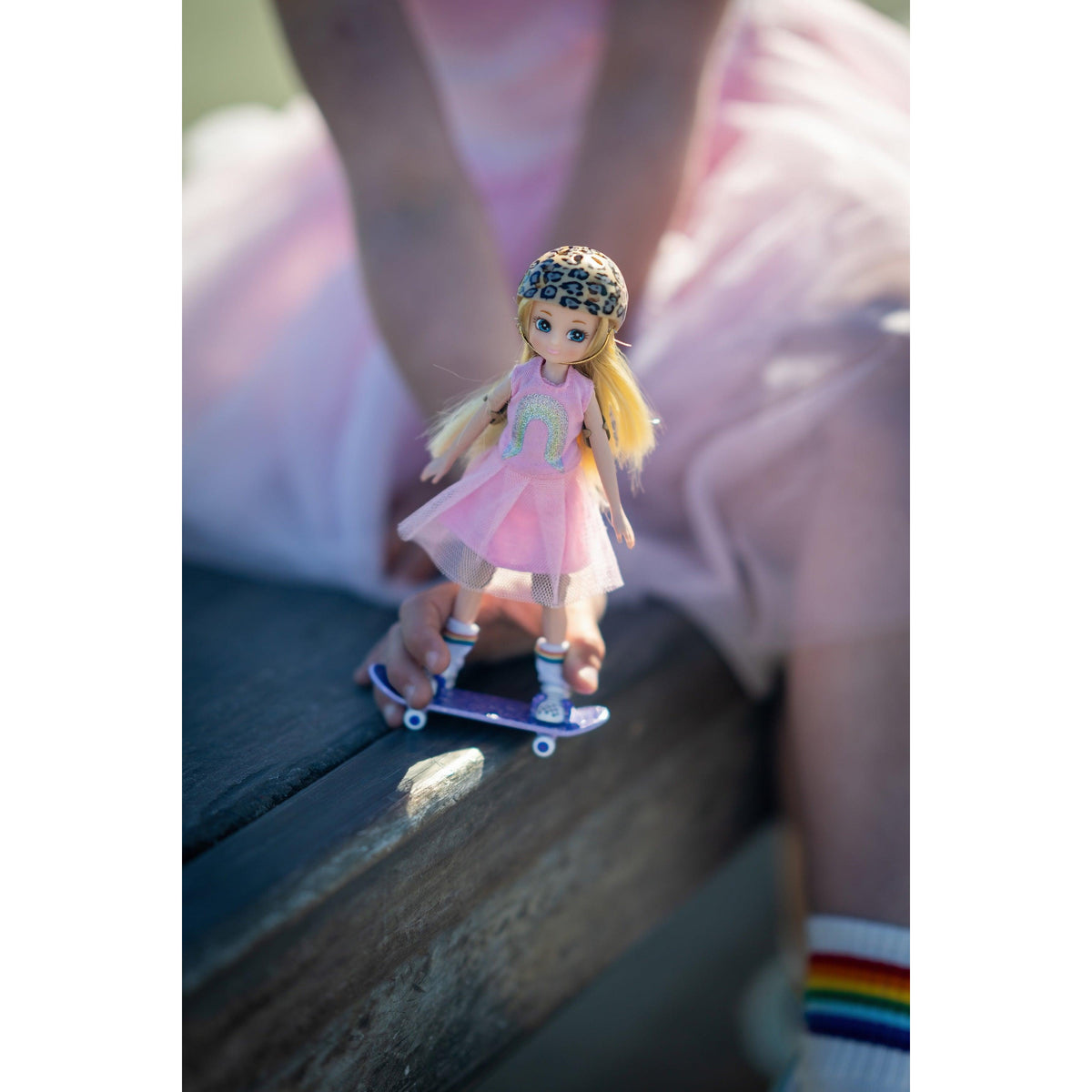 Skate Park Lottie doll on her skateboard outdoors