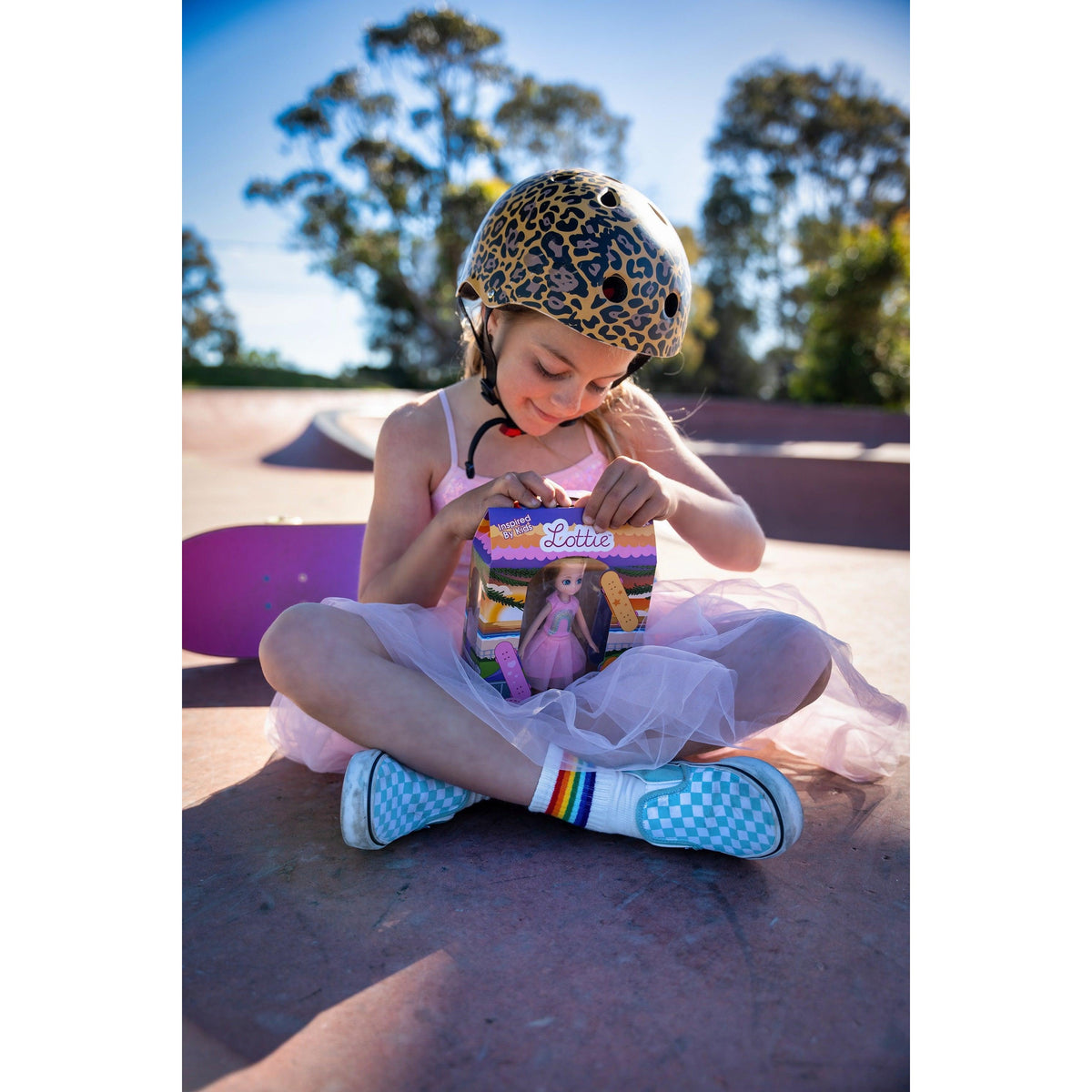 A girl skating with her Skate Park Lottie doll