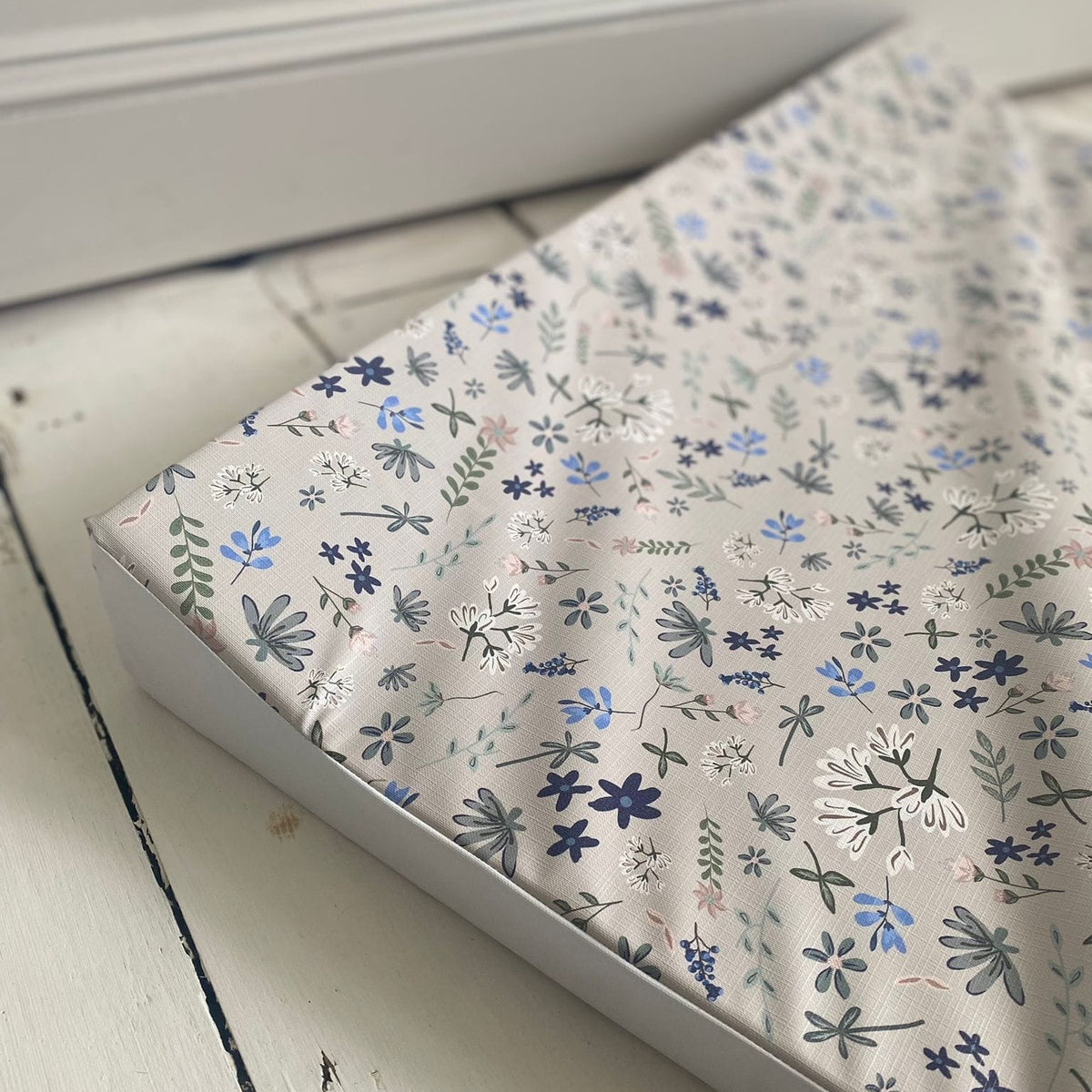 Wildflower anti-roll wedge changing mat on a nursery dresser