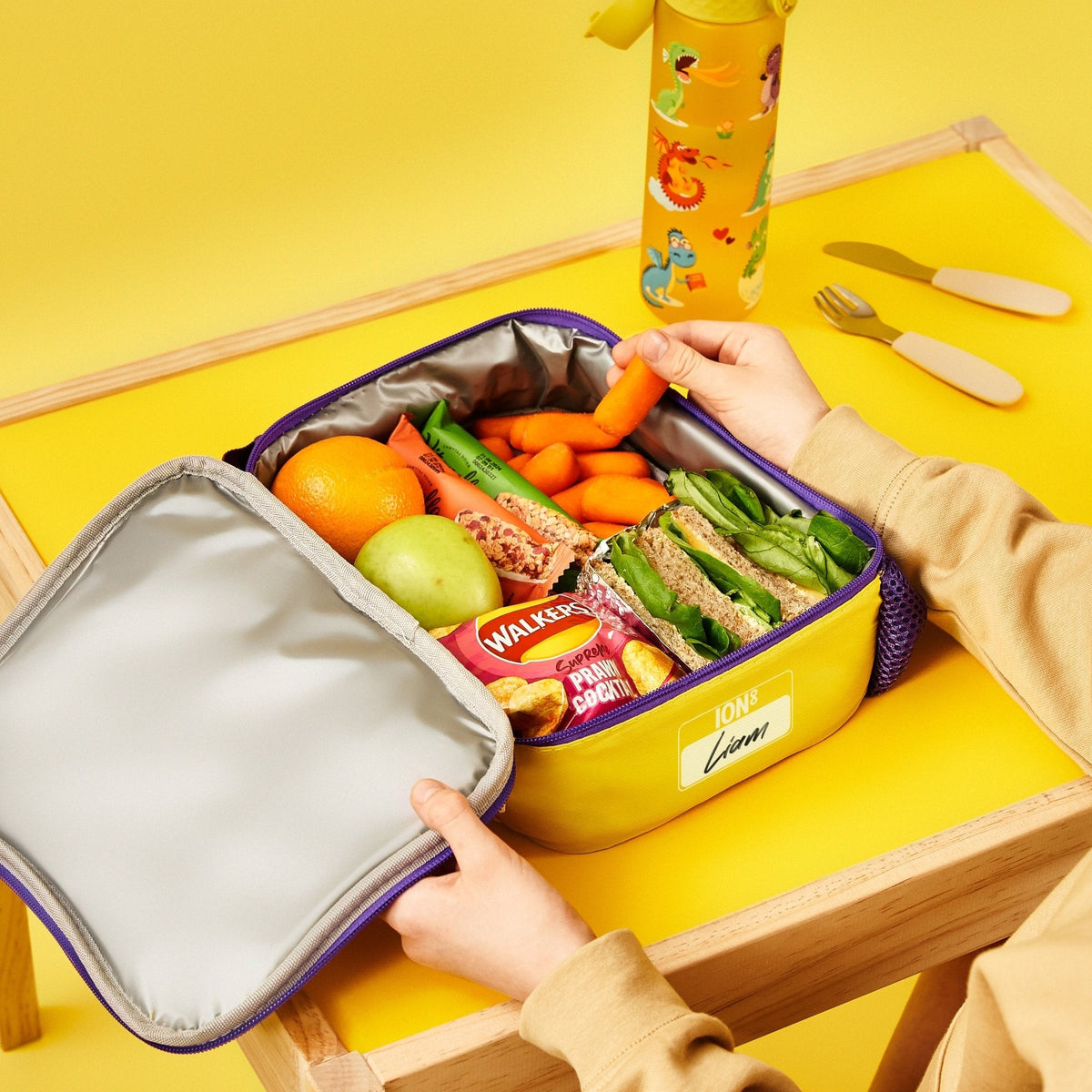 ION8 Dragons lunch bag and bottle set in use, packed with a healthy lunch