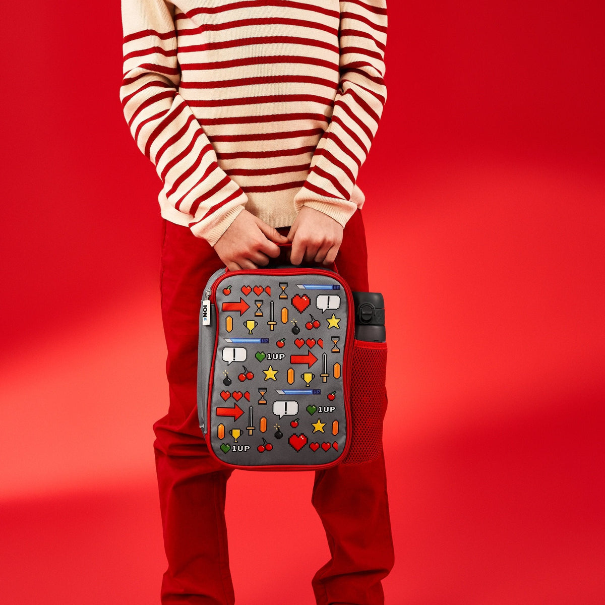 ION8 Gamer lunch bag and bottle set in use, carried by a child