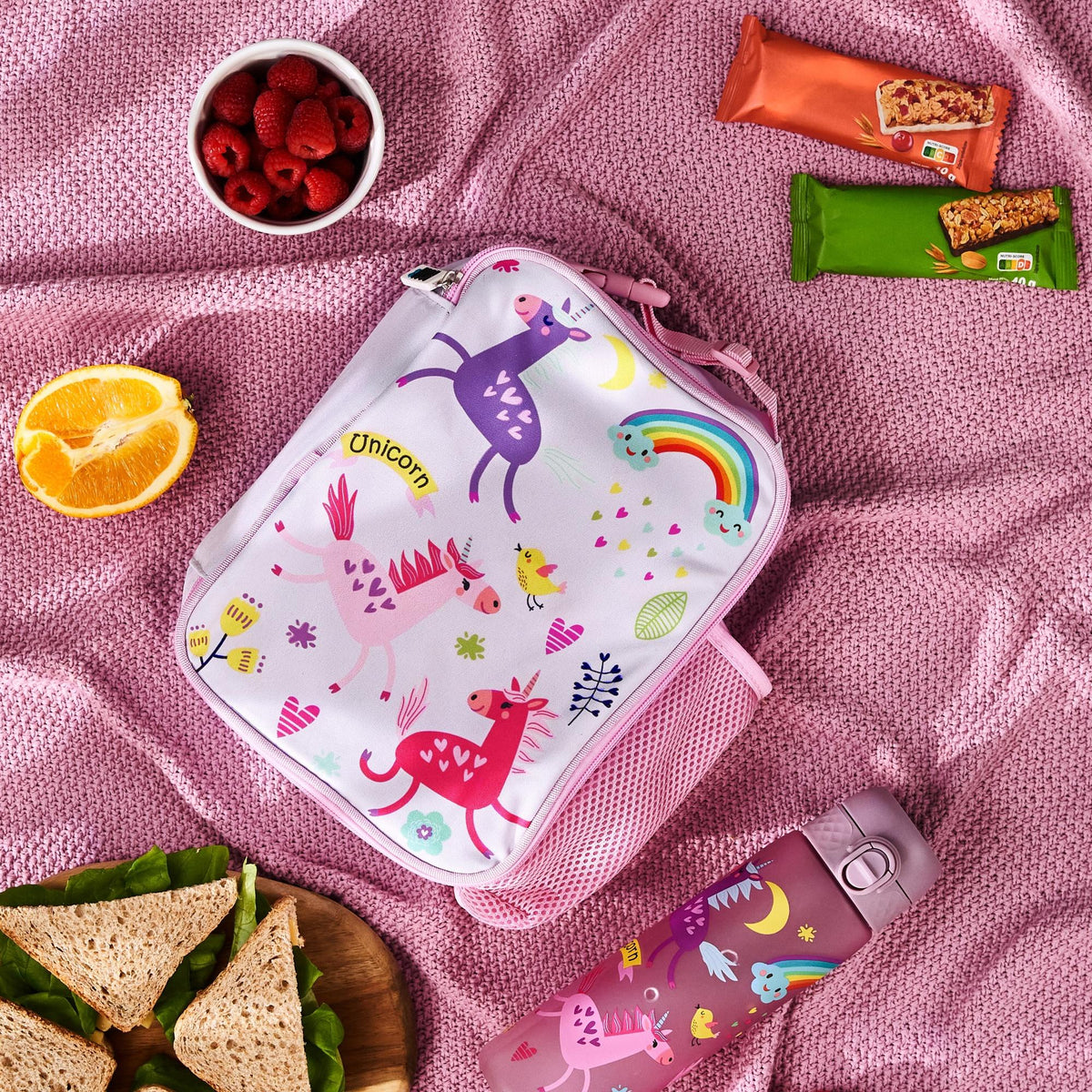 ION8 Unicorns lunch bag and bottle set in use on a picnic