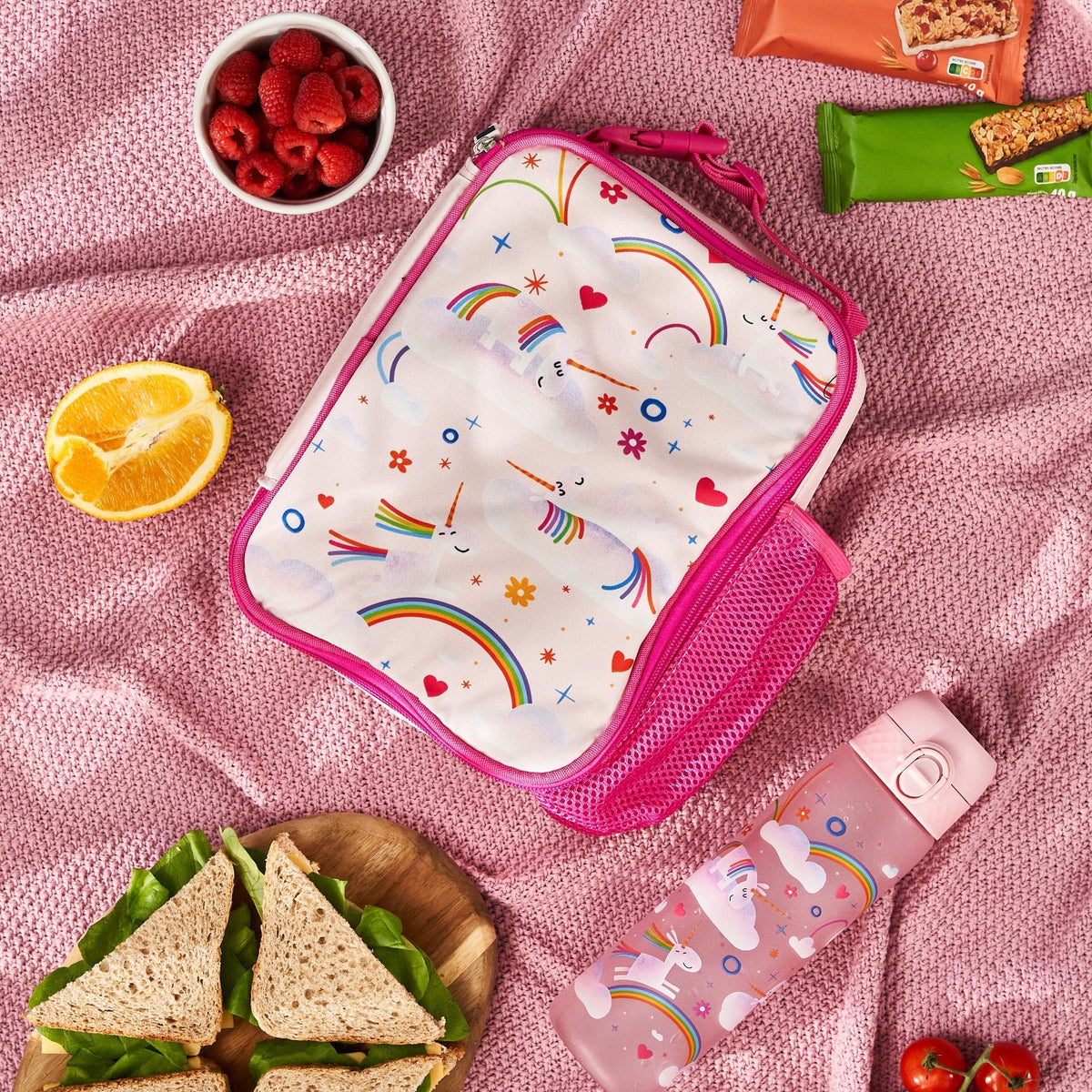 ION8 Unicorn Rainbows lunch bag and bottle set in use on a picnic