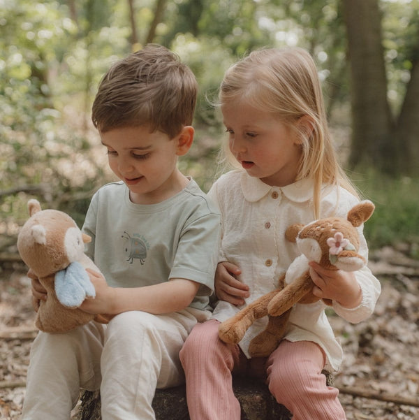 Two children playing in a garden with a Little Dutch Long Legs deer